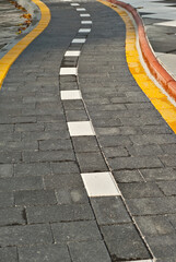 The path is lined with colorful cobblestones. Bicycle path close up.