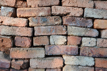Naklejka premium Brick wall without cement. Old burnt brick. Brick background. Construction Materials.