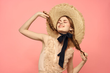 Beautiful woman in hat and in black dress ribbon portrait pink background model