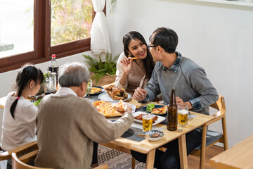 multigenerational asian family eating lunch together