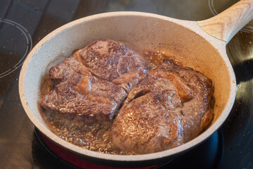 Meat concept. Pork loins chops fried in pan. Blur background, close up, above view.
