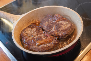 Meat concept. Pork loins chops fried in pan. Blur background, close up, above view.