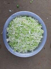 Sliced of Cabbage in the bowl. Fresh cabbage from farm field. Close up macro view of green cabbages. Vegetarian food concept. slide white cabbage closeup ready to cooking. Popular Green vegetable. 