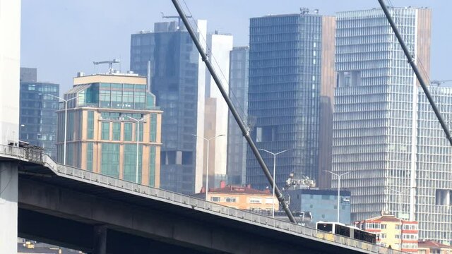 Istanbul Bosphorus Bridge with traffic and scyscraper buildings at background