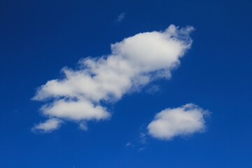 White clouds in blue sky background.