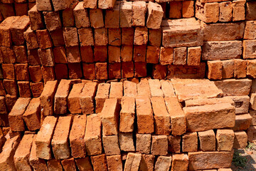 Stack of red bricks for construction purpose