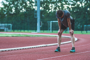 Young Caucasian man taking a break after running