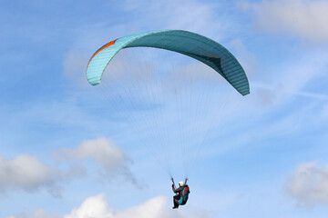 Paraglider flying wing in a blue sky	