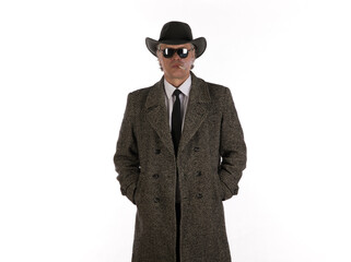Obraz na płótnie Canvas studio portrait of male businessman in gray coat and hat
