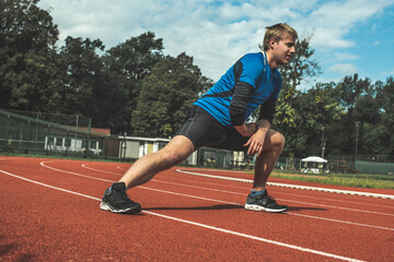 Fototapeta premium Young Caucasian man doing strength exercises, side step lunges