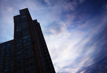 Fototapeta na wymiar Left aligned titled city building with dramatic sky