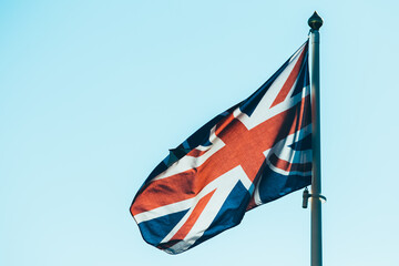 Obraz premium The flag of the UK blown by the wind.