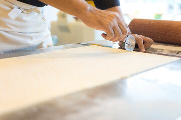 Hands baking dough with rolling pin on wooden table 
Hand, Cooking, Dough, Bread, Bakery,Croissant 