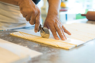 Hands baking dough with rolling pin on wooden table 
Hand, Cooking, Dough, Bread, Bakery,Croissant 