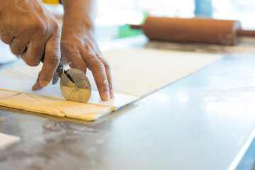 Hands baking dough with rolling pin on wooden table 
Hand, Cooking, Dough, Bread, Bakery,Croissant 