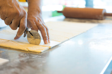 Hands baking dough with rolling pin on wooden table 
Hand, Cooking, Dough, Bread, Bakery,Croissant 