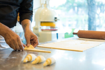 Hands baking dough with rolling pin on wooden table 
Hand, Cooking, Dough, Bread, Bakery,Croissant 