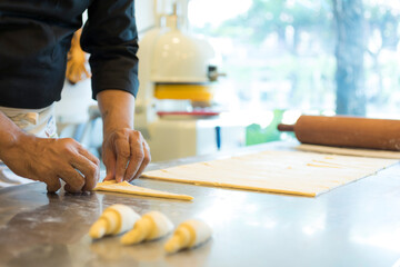 Hands baking dough with rolling pin on wooden table 
Hand, Cooking, Dough, Bread, Bakery,Croissant 