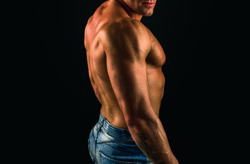 Fototapeta premium Man with sexy body. Strong stripped muscle male model in black underwear on balck isolated.