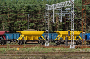 WAGONS WITH CRUSHED STONE - Color railway on the sidetrack

