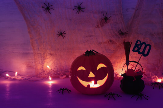 holidays halloween concept image. Pumpkin, spiders over wooden table
