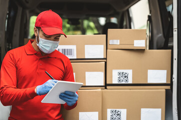 Delivery man wearing face protective mask to avoid corona virus spread - Young express courier...