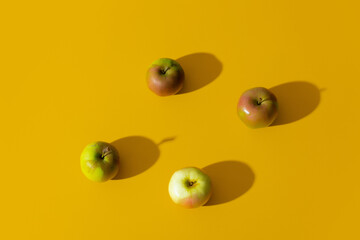 Group of apples on yellow background