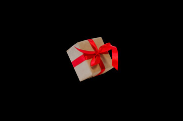 Gift box with red ribbon, copy space isolated on black background. Sales concepts, discount price, black friday, christmas gifts and shopping, greeting card for christmas, valentine's day or new year
