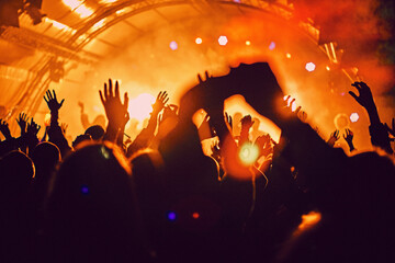 Abstract blur atmosphere: happy people enjoying outdoor music festival concert, raised up hands and...