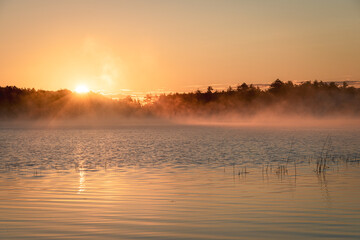 Morning fog and sunrise at Lower Togue Pond, in Baxter State Park, Maine