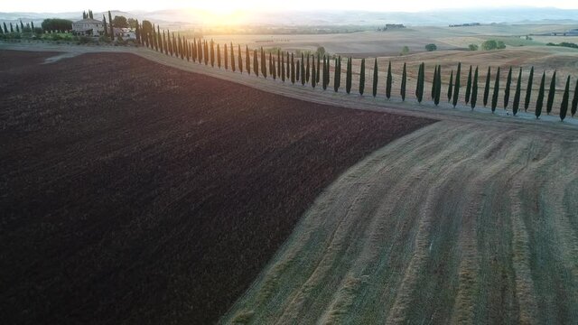 Aerial view of the sunrise in the valley of the orc, the sun just arose, the countryside in Tuscany