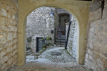 A narrow street between the old houses of Fumone, a medieval village in the province of Frosinone, Italy.