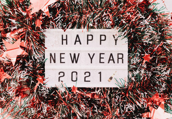 Festive red garland with happy new year 2021 lettering in the center. Close up. Christmas mood. 
