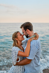 Young couple in love hug on the seashore, romantically spend time enjoying each other and vacation.