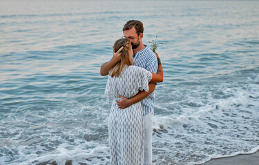 Young couple in love hug on the seashore, romantically spend time enjoying each other and vacation.