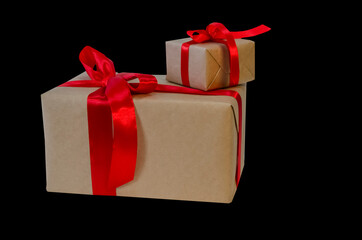 hands hold gift box with red ribbon, copy space isolated on black. Sales concepts, discount price,...