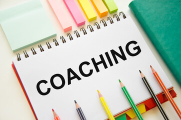 coaching text written on notepad. Coach motivate to personal development, success and career growth from the beginning.