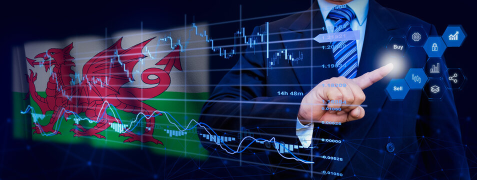 Businessman touching data analytics process system with KPI financial charts, dashboard of stock and marketing on virtual interface. With Wales flag in background.