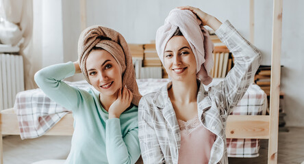 Two girls make homemade face and hair beauty masks. Cucumbers for the freshness of the skin around the eyes. Women take care of youthful skin