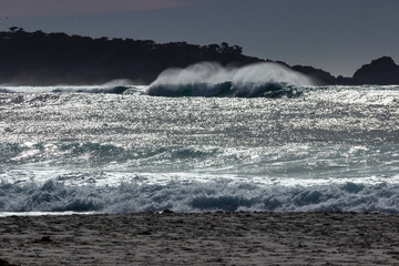 Waves breaking on the beach near the town of Carmel on the pacific coast  of California
