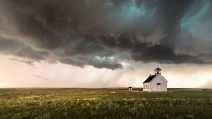 An old abandoned Church in the countryside at sunset. The scene is very dramatic and spiritual. 
