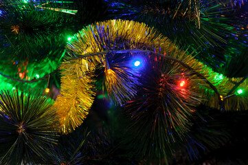 Obraz na płótnie Canvas Bright garlands m tinsel on the tree. New Year's Holidays.