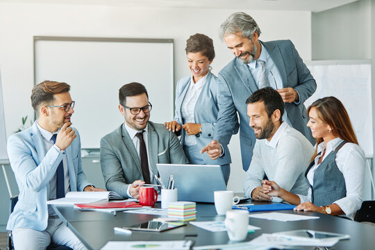 young business people meeting office teamwork group success corporatye discussion senior laptop
