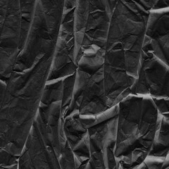 Black vintage and old looking crumpled paper background. Retro cardboard texture. Grunge paper for drawing. Ancient book page. Present wrapping.