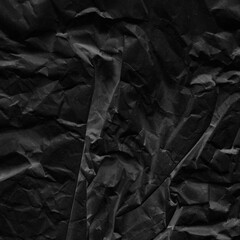 Black vintage and old looking crumpled paper background. Retro cardboard texture. Grunge paper for drawing. Ancient book page. Present wrapping.