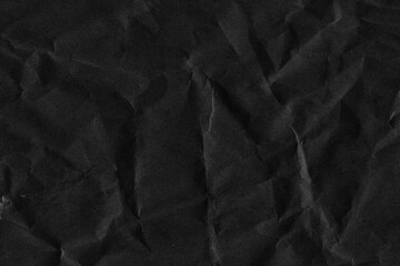 Fototapeta premium Black vintage and old looking crumpled paper background. Retro cardboard texture. Grunge paper for drawing. Ancient book page. Present wrapping.
