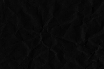 Black vintage and old looking crumpled paper background. Retro cardboard texture. Grunge paper for drawing. Ancient book page. Present wrapping.