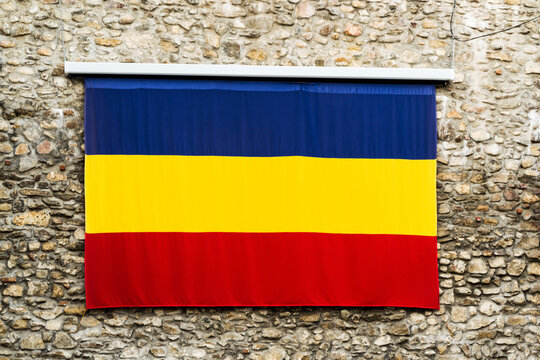 Romanian flag on a brick wall. Satin texture of flag of Romania.