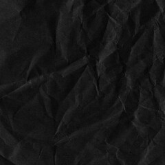 Black vintage and old looking crumpled paper background. Retro cardboard texture. Grunge paper for drawing. Ancient book page. Present wrapping.