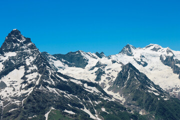 Fototapeta na wymiar Caucasus Mountains Under Snow And Clear Blue Sky